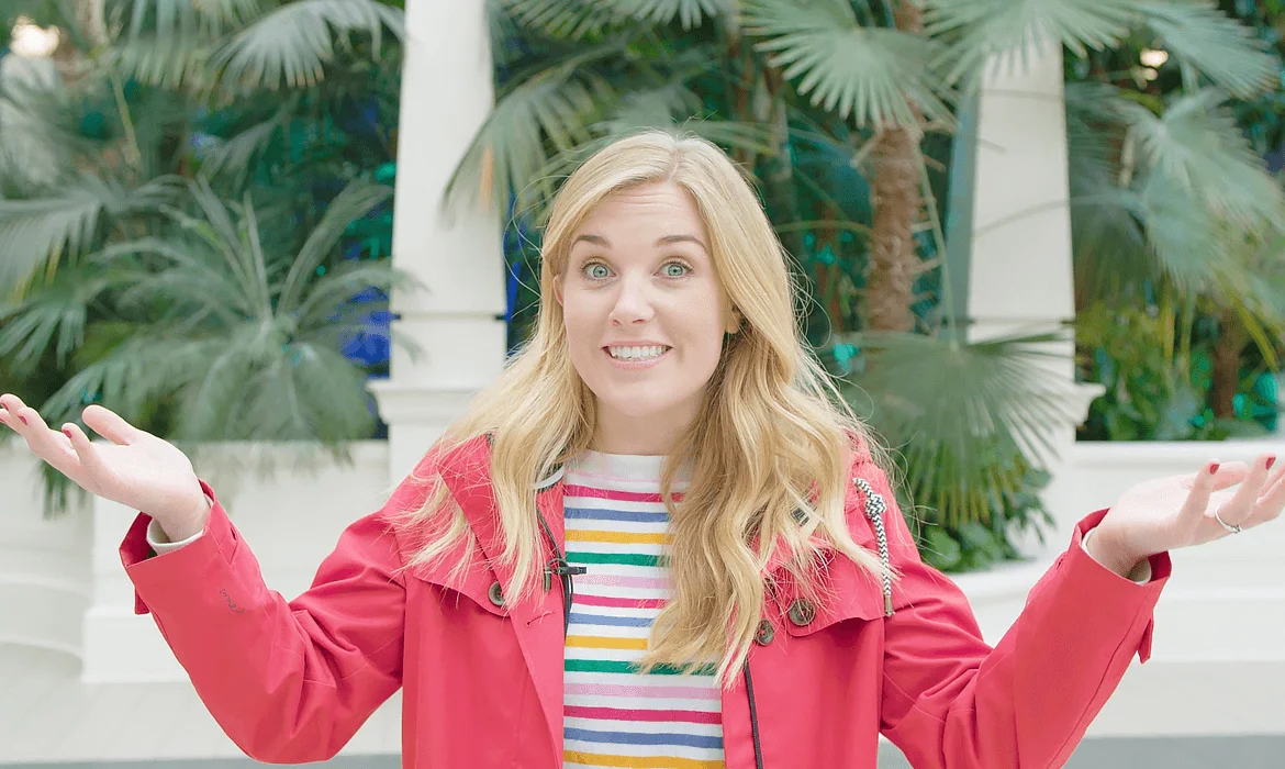 A woman with long blonde hair wearing a red coat
