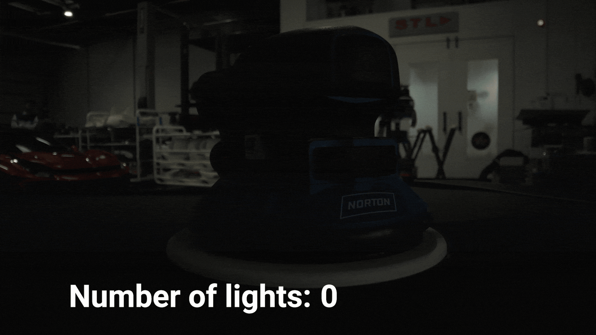 An electric sander is in the centre of the frame. Lights gradually turn on one by one