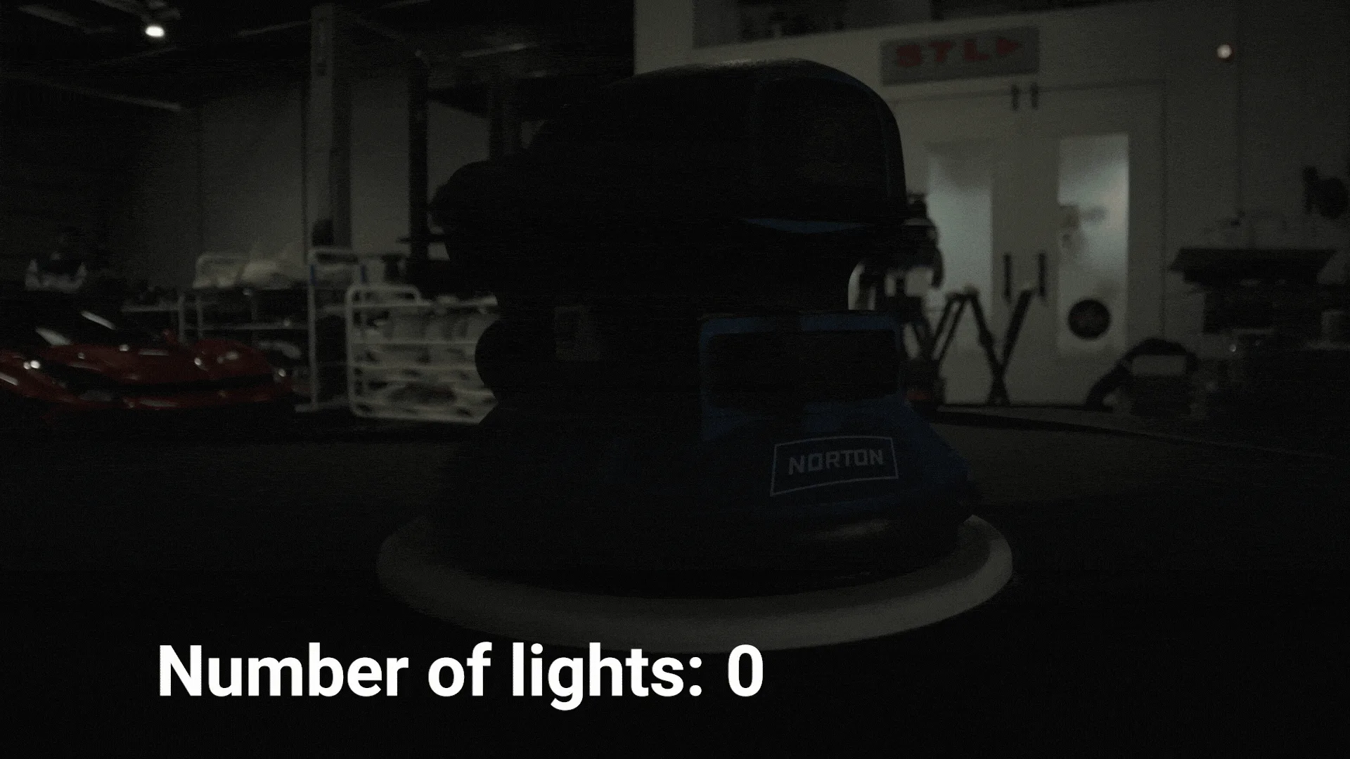 Lighting Comparison 16x9vcompressed An Electric Sander Is In The Centre Of The Frame. Lights Gradually Turn On One By One