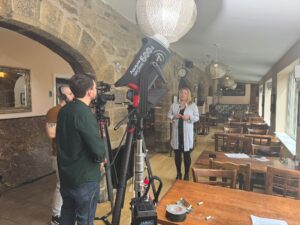Turps Film crew setting up a presenter-led corporate shoot in a restaurant